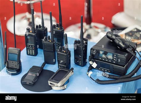 Many portable radio transceivers on table at technology exhibition ...