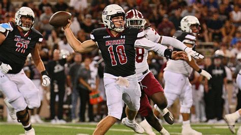 New Mexico State's Diego Pavia tries to make play with helmet twisted ...