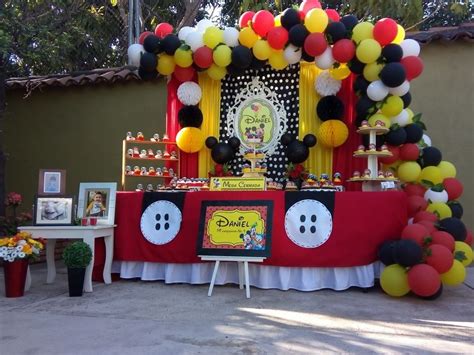 a mickey mouse birthday party with balloons and decorations