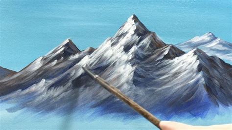 a painting of mountains with a paintbrush in the foreground and someone ...