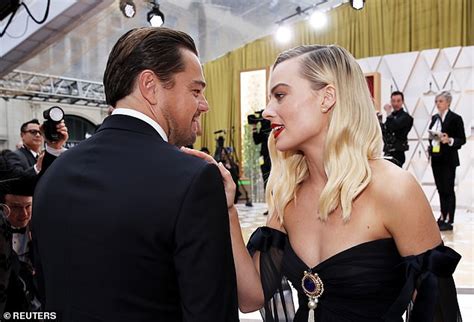 Margot Robbie and Leonardo DiCaprio reunite at the Oscars as her husband Tom Ackerley watches on ...