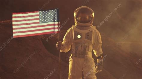 Astronaut plants US flag on Mars - Stock Video Clip - K010/6074 - Science Photo Library