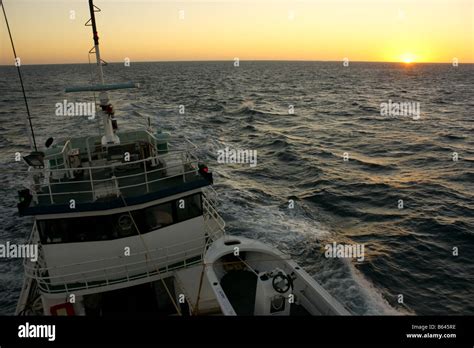 sunrise on a deep sea crab fishing boat Stock Photo - Alamy