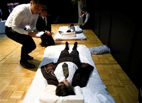 Judges check a model after a funeral undertaker dressed up the model ...