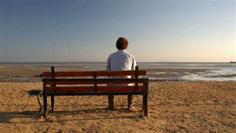 Young Man Sitting Alone On The Bench On The Beach Stock Footage Video ...