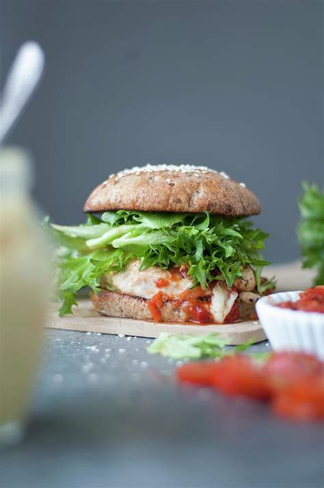 A Gourmet Chicken Burger With Mayonnaise And Tomatoes Photograph by ...