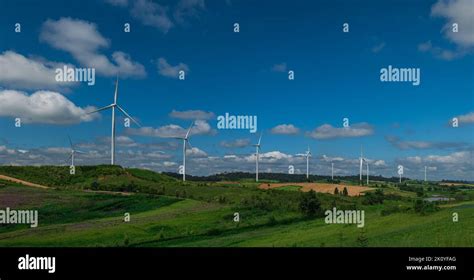 Countryside landscape of hills and turbines field with blue sky cloud ...