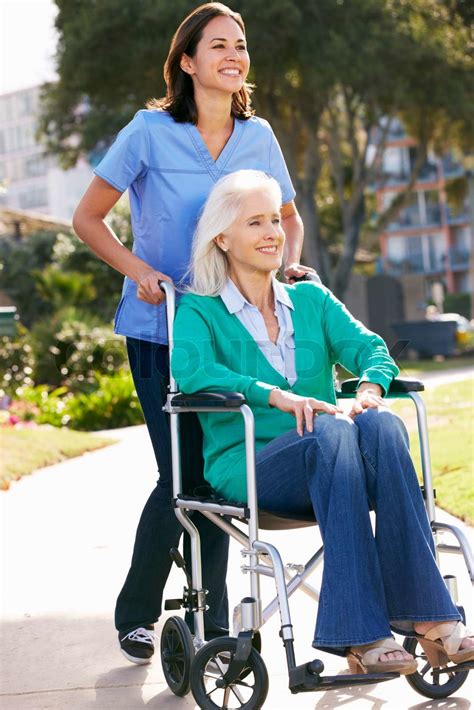 Carer Pushing Senior Woman In Wheelchair | Stock image | Colourbox