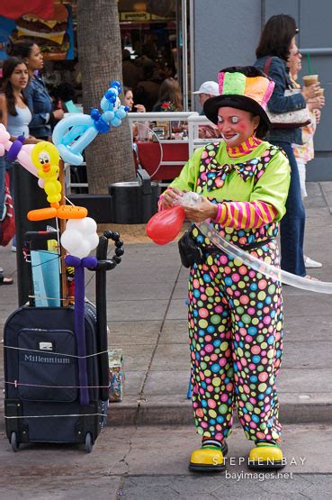 Photo: Clown making balloon animals. Third Street Promenade, Santa Monica, California, USA.