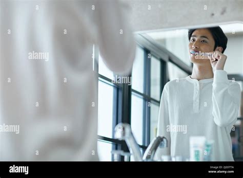 Japanese man brushing teeth Stock Photo - Alamy