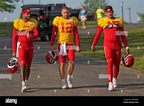 Kansas City Chiefs quarterbacks Chris Oladokun, left, Shane Buechele (12) and Patrick Mahomes ...