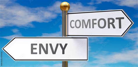 Envy and comfort as different choices in life - pictured as words Envy, comfort on road signs ...