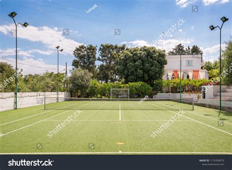 Football field and tennis court next to beautiful villa. Concept of ...