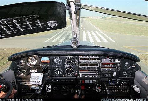 the view from inside an airplane looking at the cockpit and landing gear on the tarmac