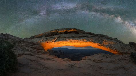 Milky Way Galaxy panorama over a lit Mesa Arch in Canyonlands National ...