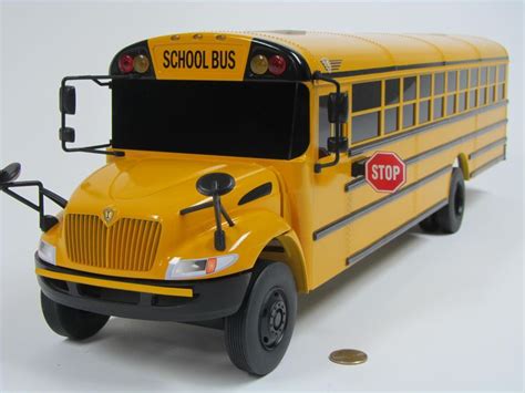 a toy school bus is shown on a white background with a coin in the ...