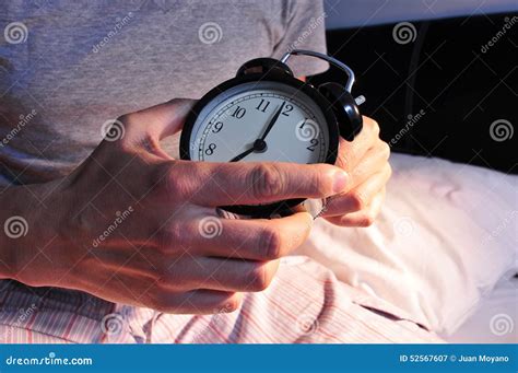 Young Man in Bed Setting the Alarm Clock Stock Image - Image of pyjamas, house: 52567607