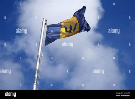 The flag of Barbados - a black broken trident on a triband of two bands ...