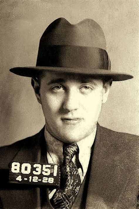 a man wearing a suit and tie with a hat