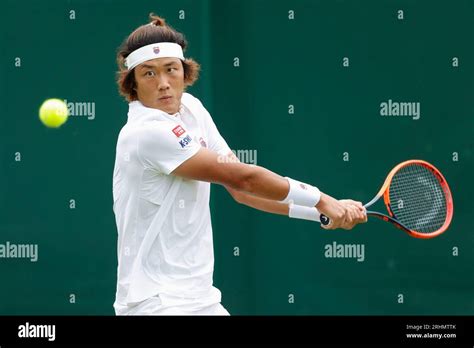 Tennis player Zhizhen Zhang of China in action at the 2023 Wimbledon ...