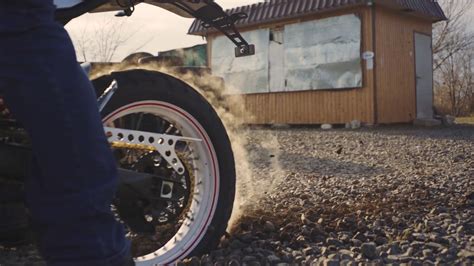 Motorcyclist doing tire burnout in the desert, slow motion. Professional motorcyclist drift and ...