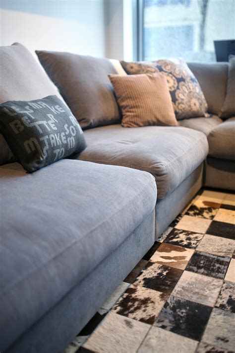 Comfortable grey couch with pillows · Free Stock Photo