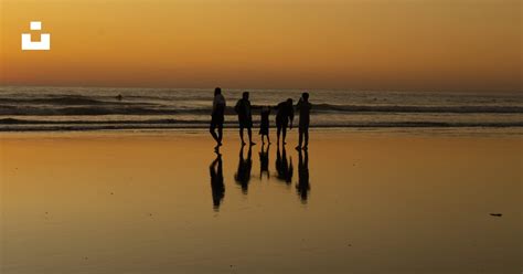 A group of people walking on a beach photo – Free Beach Image on Unsplash