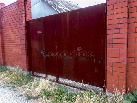 Steel Rusty Gates and a Red Brick Fence. Stock Photo - Image of gate, castle: 103613124