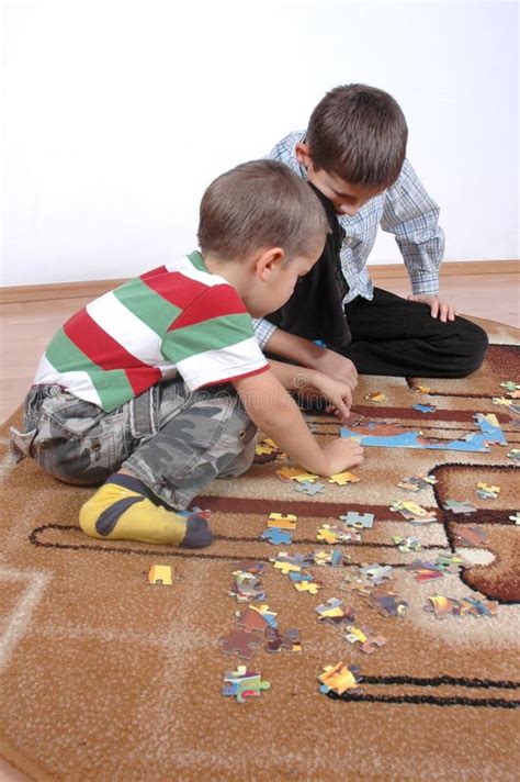 Boys playing the puzzle stock image. Image of enigma - 11588637