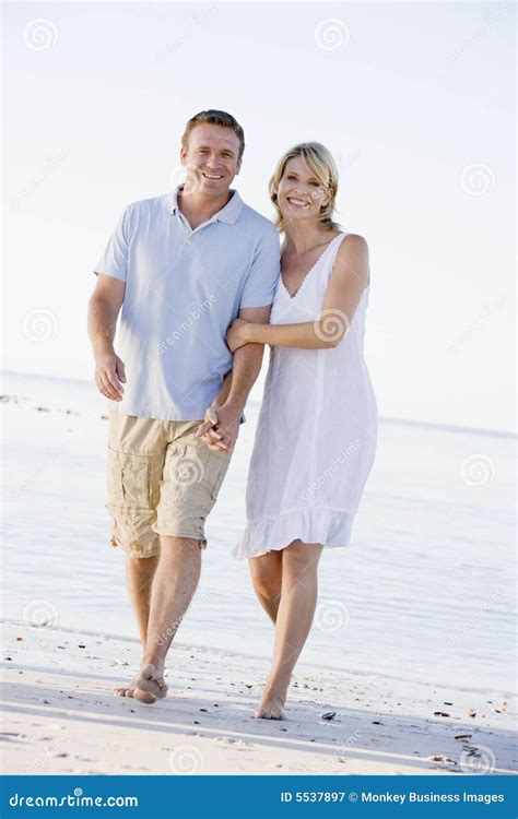 Couple at the Beach Holding Hands and Smiling Stock Image - Image of length, male: 5537897