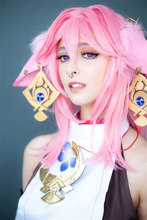 Female Cosplayer in a Pink Anime Costume Wearing Pink Hair Stock Photo - Image of anime, raises ...