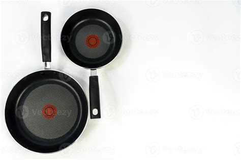 teflon cooking pans, black teflon on white background, plastic handles ...