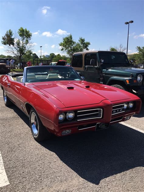 Musclecar Era — 1969 “Matador Red” Pontiac GTO convertible. This...