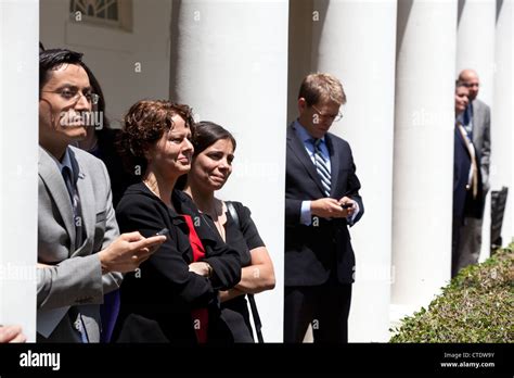 White House staff members listen from the Colonnade of the White House ...