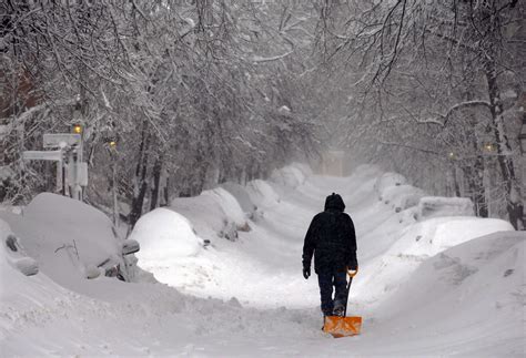 Boston: A man drags a shovel up Beacon Hill.