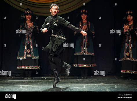 Georgian children dressed with traditional costumes dancing a folklore dance show on stage Stock ...