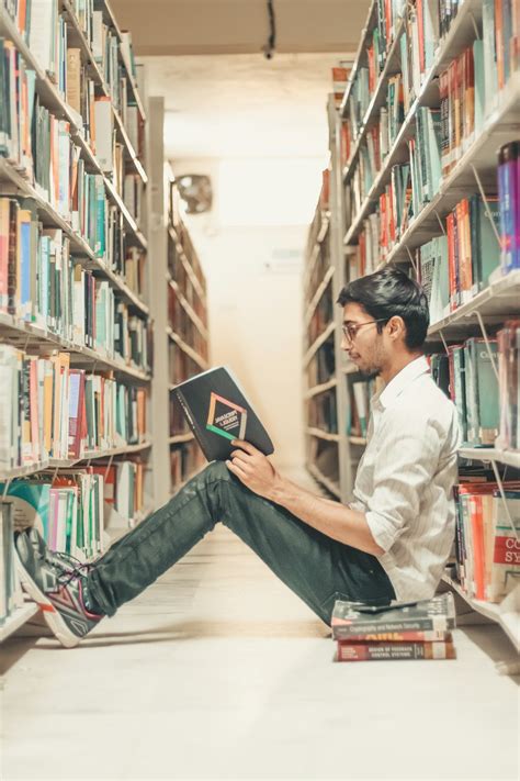 Man reading book on the library photo – Free Young student Image on Unsplash