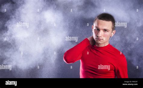 Young fitness athlete is posing in studio with black background Stock Photo - Alamy