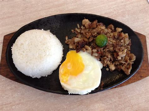 Sizzling sisig, rice, and egg at Razon's. Yummy local dish! | Flickr - Photo Sharing!