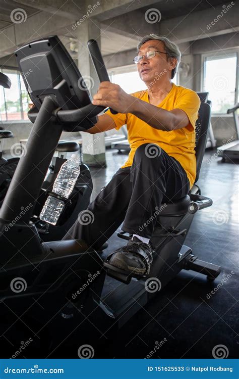 Senior Older Man Exercising on Cycling Machine Relaxing in Fitness Gym ...