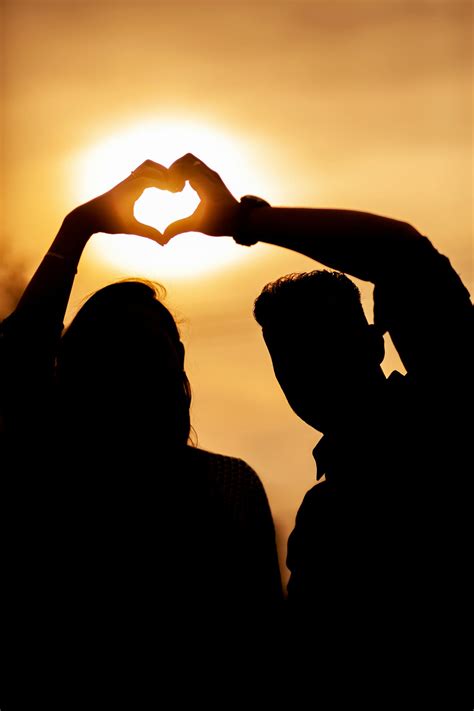 Silhouette of couple with heart at sunset · Free Stock Photo