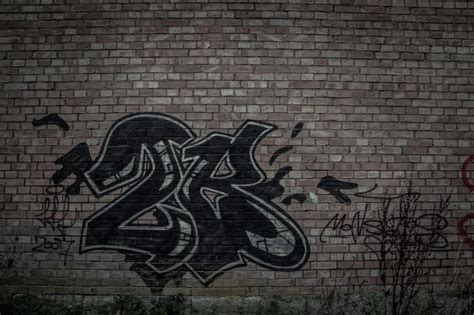 Black Brick Wall With Graffiti - HD Wallpaper | Black brick wall, Black brick, Brick wall