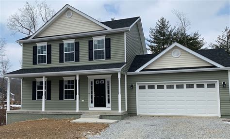 Beautiful craftsman style house with green siding and black shutters. | Green siding, Siding ...