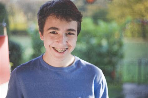 Portrait of a smiling teenage boy with braces stock photo