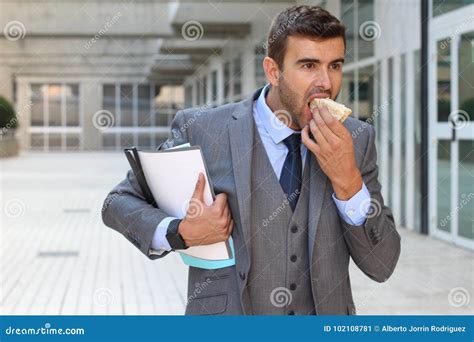 Businessman Walking and Eating at the Same Time Stock Image - Image of ...