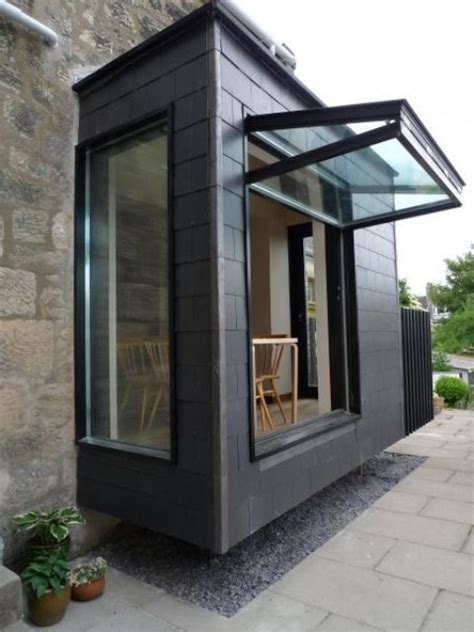 a vertically folding window that takes almost the whole wall opens the breakfast space to the ...