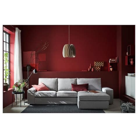 a living room with red walls and white furniture