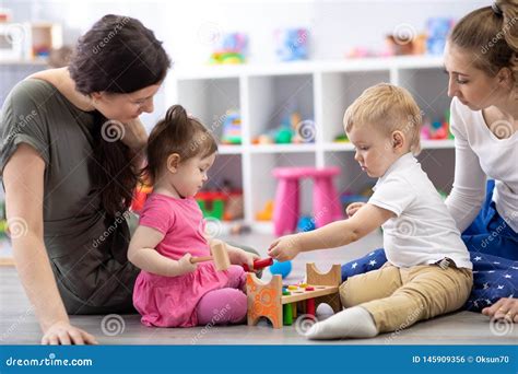 Group of Babies Playing Together with Mothers in the Classroom in Nursery or Preschool Stock ...