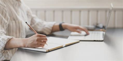 Man Writing in a Book · Free Stock Photo