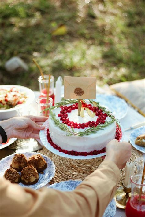 White and Red Cake With Lighted Candles on Table · Free Stock Photo